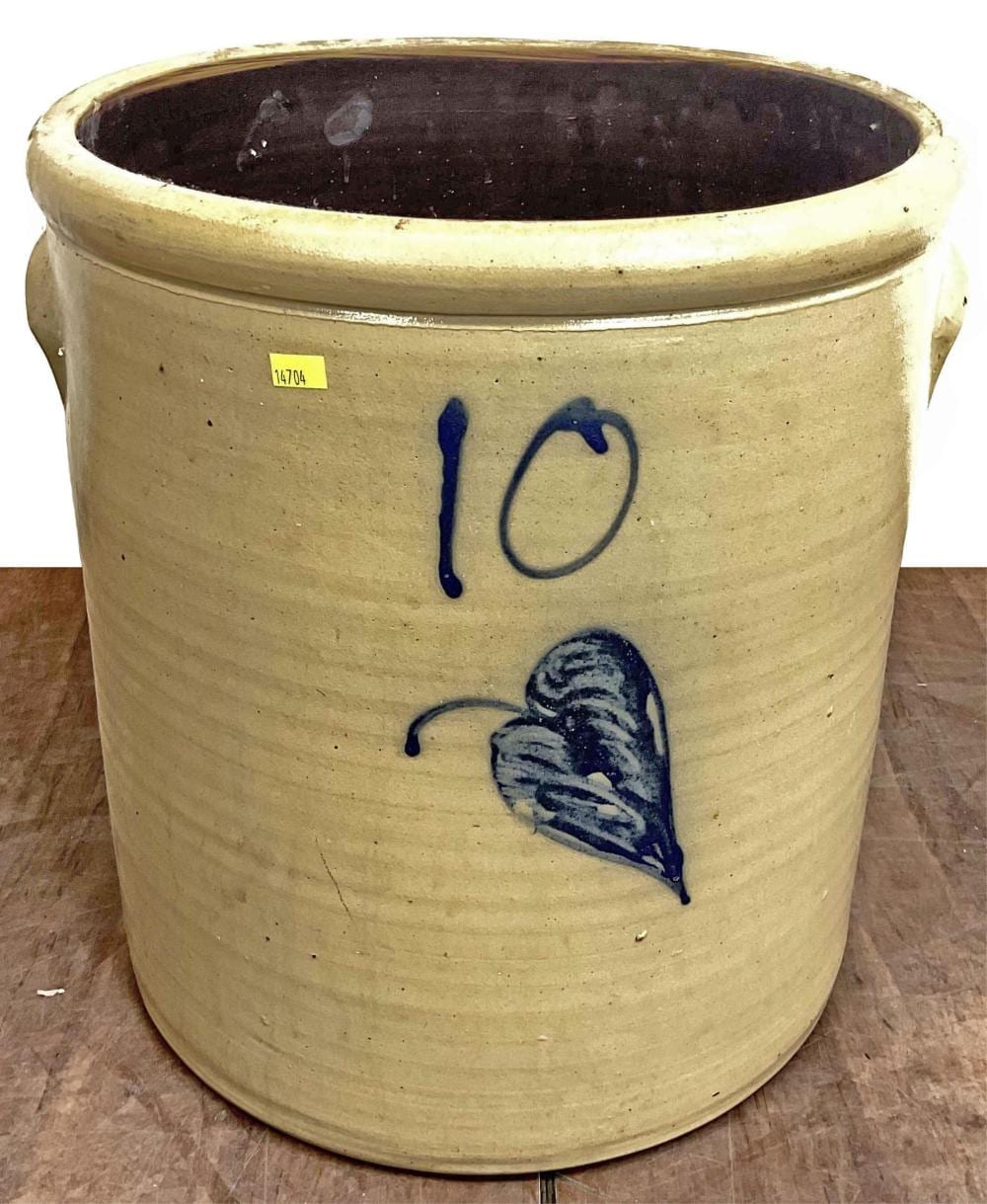 Salt-glazed stoneware crock with rounded rim and blue painted decoration (number "10" and leaf/flower motif) on a light tan body.