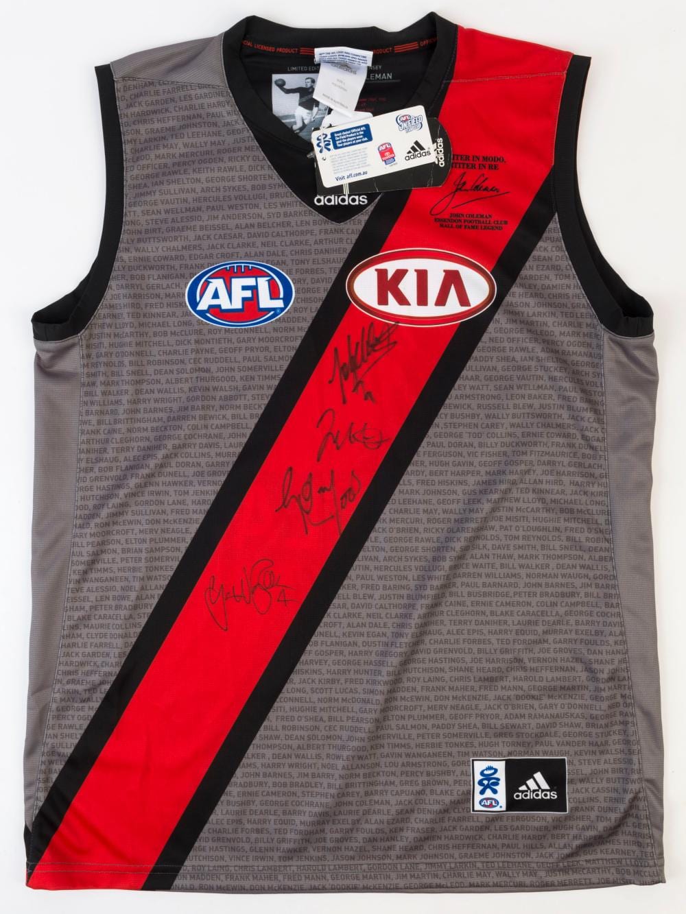 ESSENDON: Adidas 2013 'John Coleman' limited edition Adidas guernsey (size L), signed by Brownlow Medal winners Graham Moss, Gavin Wanganeen, James Hird & Jobe Watson. sold by Leski Auctions Pty Ltd, lot 507 — auction record photograph