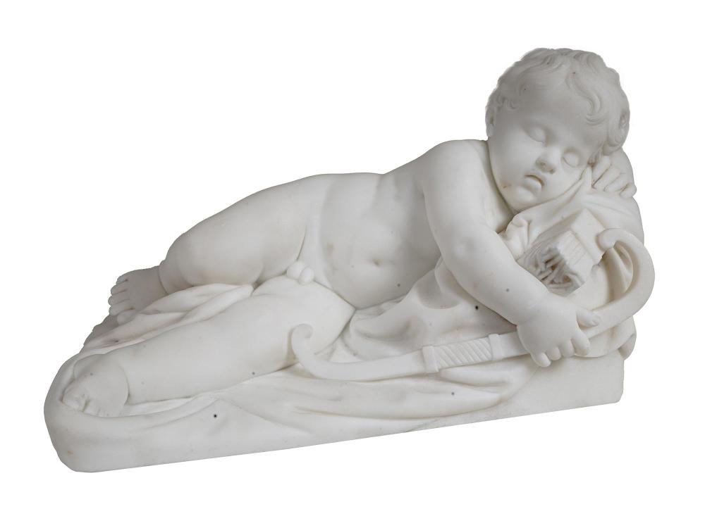 White marble sculpture of a sleeping cupid or child figure reclining and holding a small object near its face.