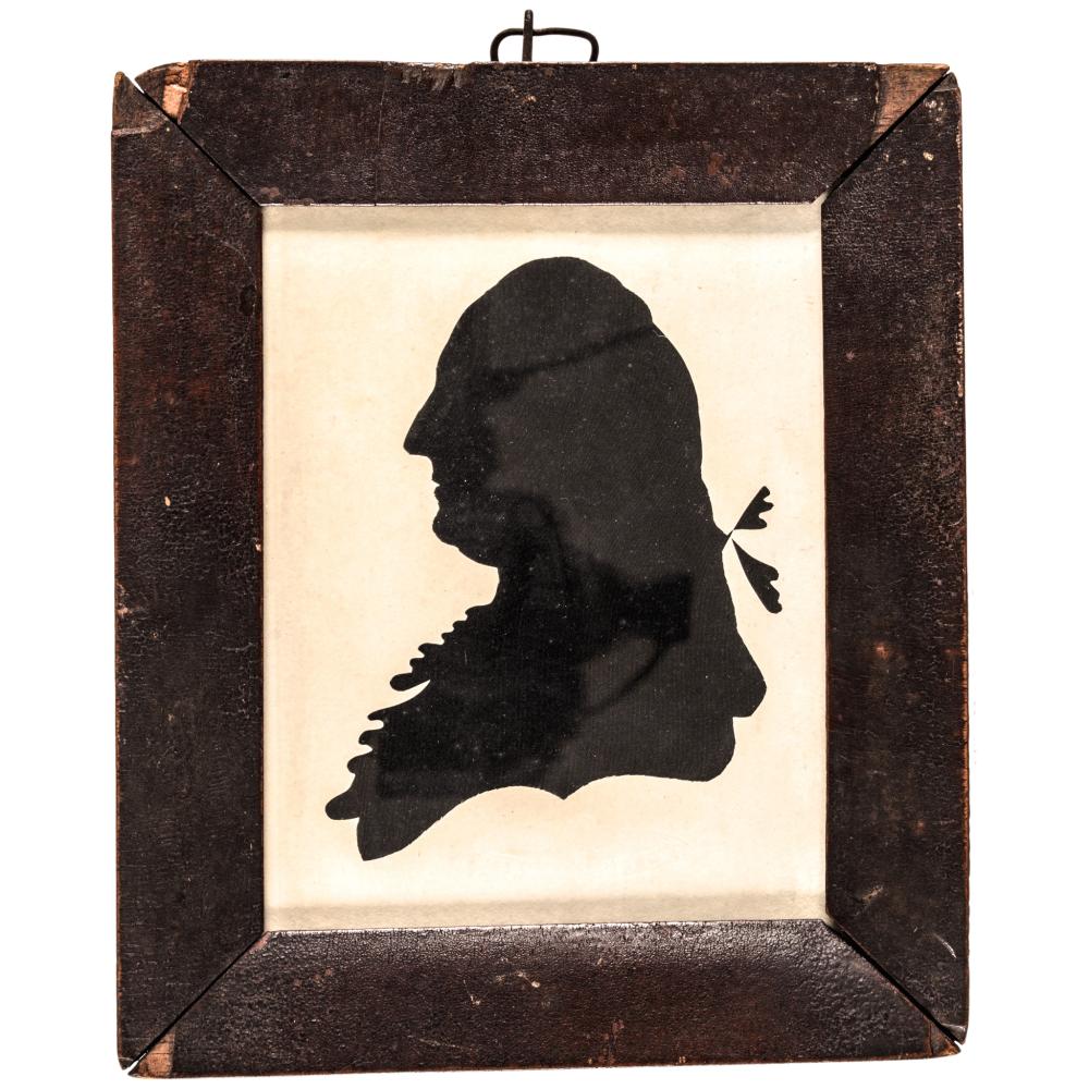 Silhouette portrait of a man in profile facing left, mounted in a dark rectangular frame with a light background.