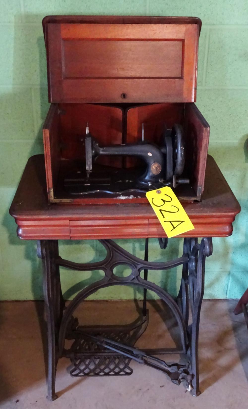 Antique Singer Treadle Sewing Machine: wood case, iron base sold by Roan Inc. Auctioneers & Appraisers, lot 32A — auction record photograph