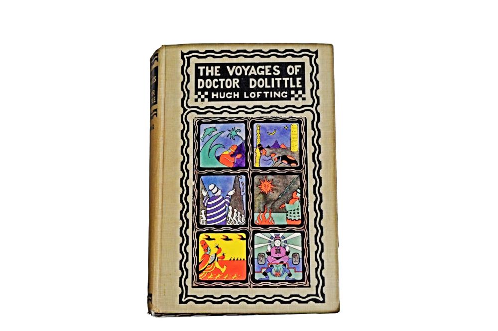 Front cover of an illustrated hardcover book titled “The Voyages of Doctor Dolittle” with colorful animal and character scenes in framed panels.