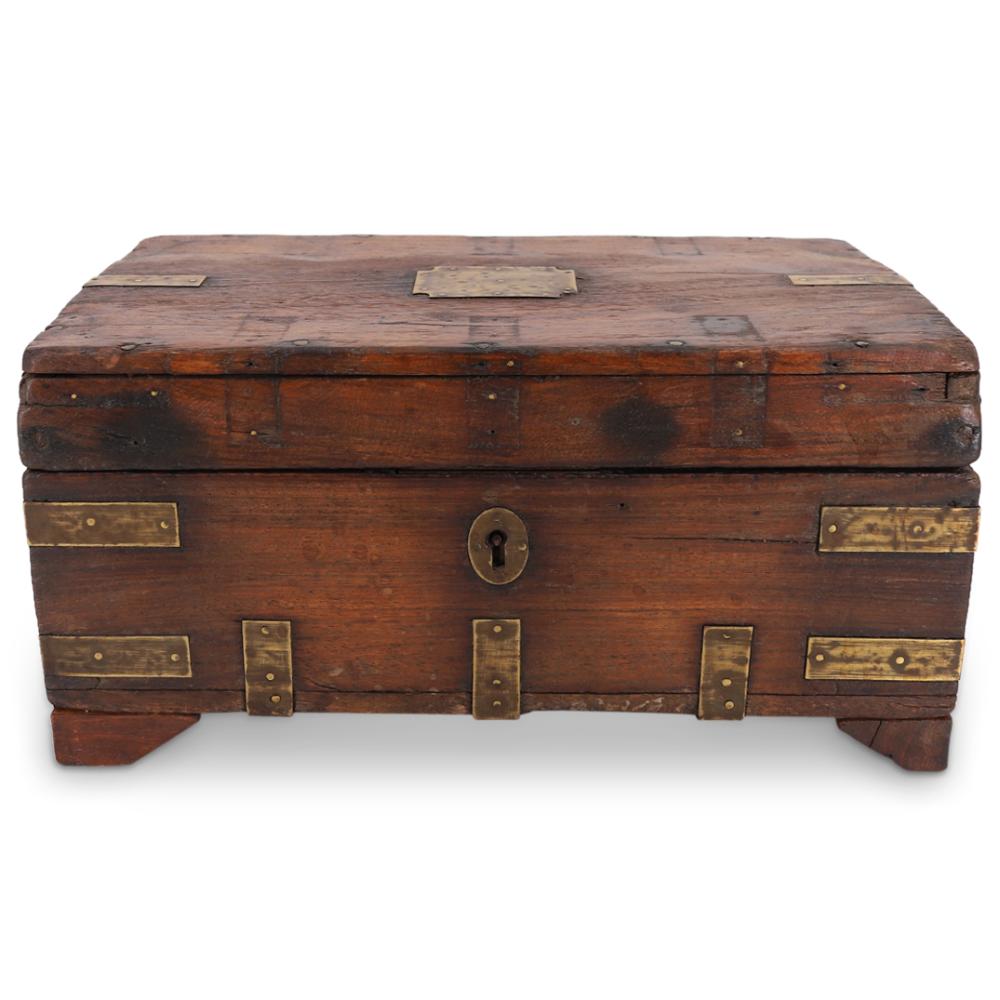 Antique-style wooden cash box with a brass keyhole on the front and brass corner and plate details on a hinged lid.