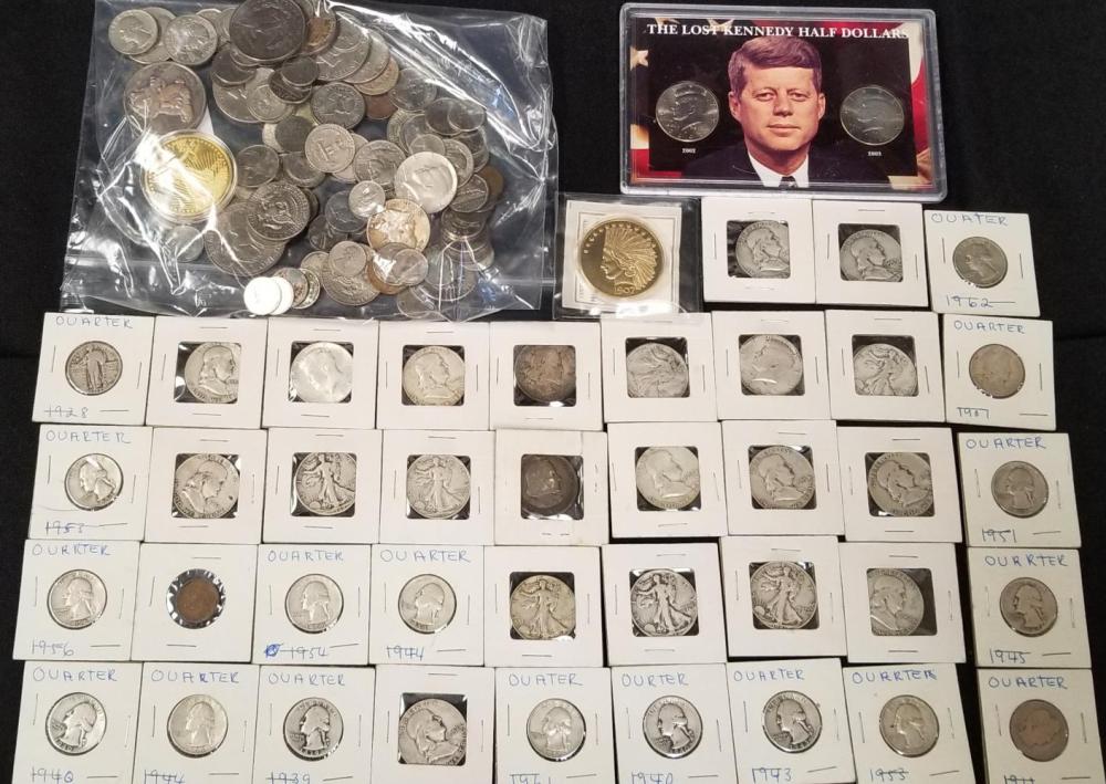 Assorted U.S. coin collection laid out in plastic bags and labeled envelopes, including quarters and half dollars.