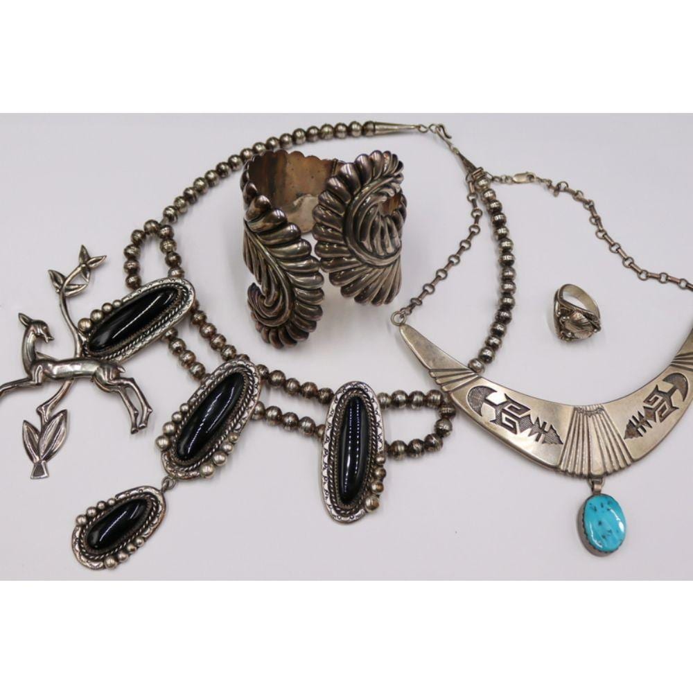Southwestern-style silver-tone bead necklaces with black oval insets and turquoise cabochon pendant, plus a pair of silver-tone earrings.