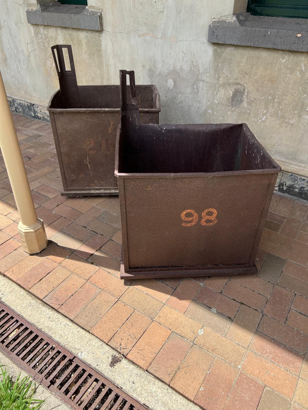 Two vintage cast iron trolley-crates,one labelled 98 sold by Artvisory, lot 56 — auction record photograph