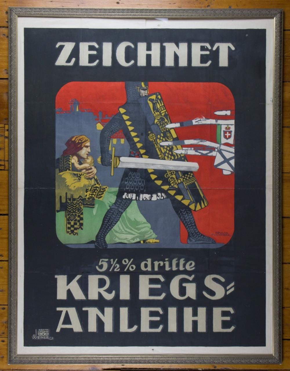 Framed World War I-era poster with the words “ZEICHNET” and “KRIEGS-ANLEIHE” above and below an illustration of soldiers and a red shield.