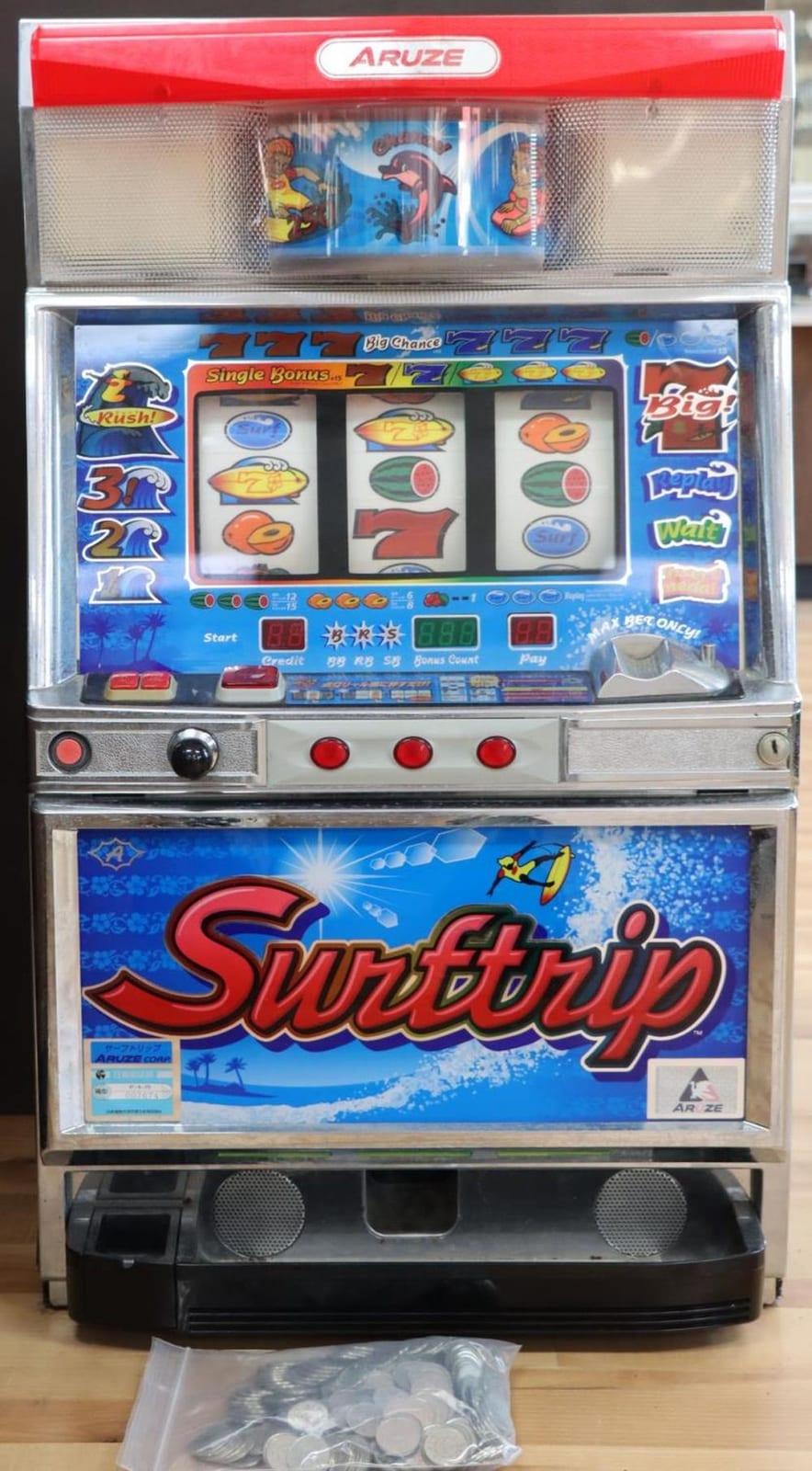 Front view of a red and silver Japanese slot machine with colorful reels, buttons, and “Supertripp” branding.