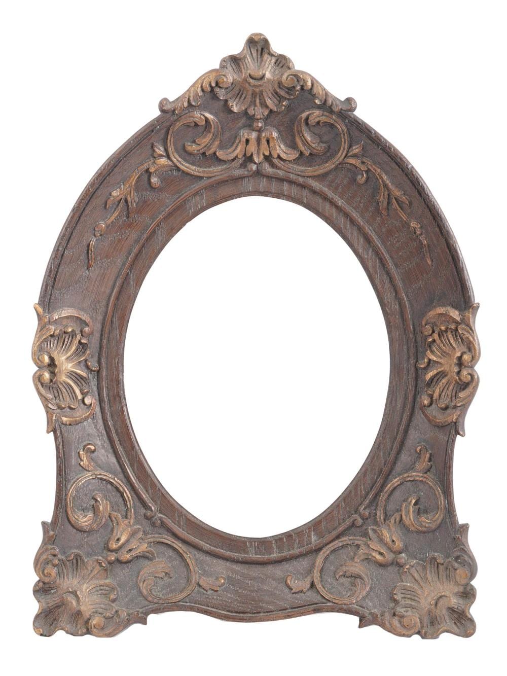 Oval picture frame with dark carved wood scrollwork and floral Rococo-style ornament on a white background.