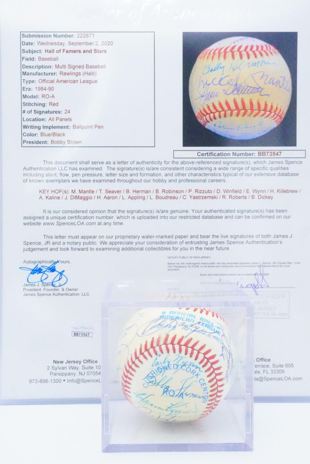 Photograph of a signed official baseball with blue and black autographs on the ball, shown with printed paperwork.