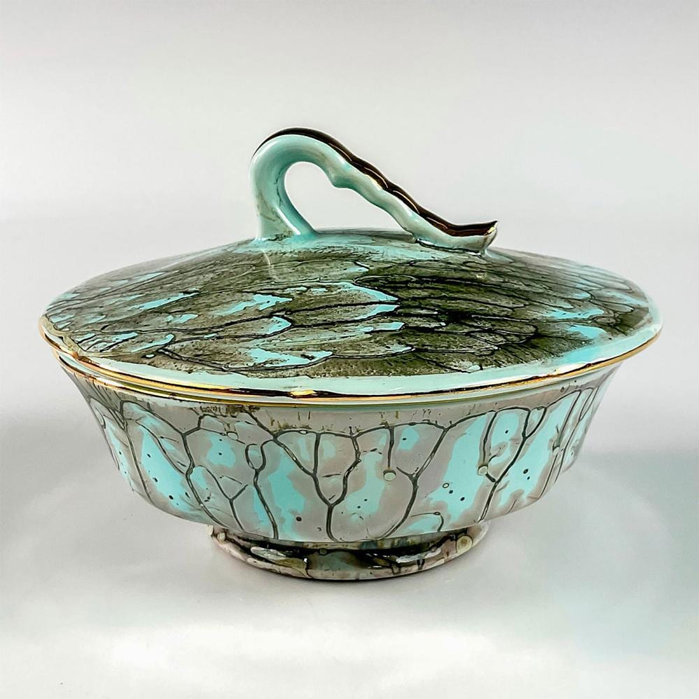 Turquoise ceramic covered candy dish with a lid, textured crackle pattern, and gold rim on a white background.