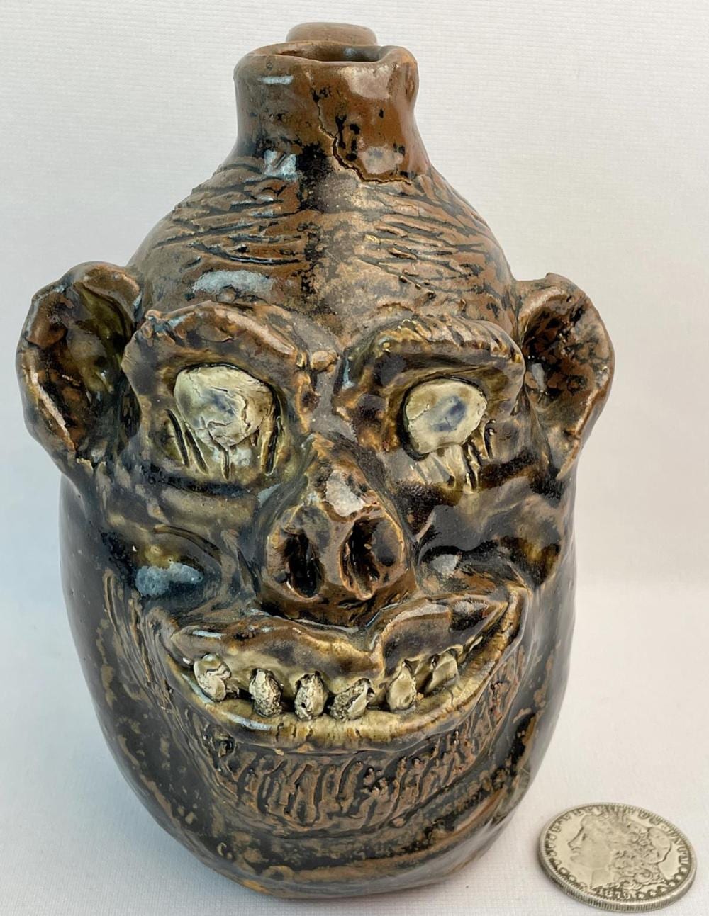 Marie Rogers comparable auction result: marie rogers b 1922 d 2010 pottery face jug 7 5 tall