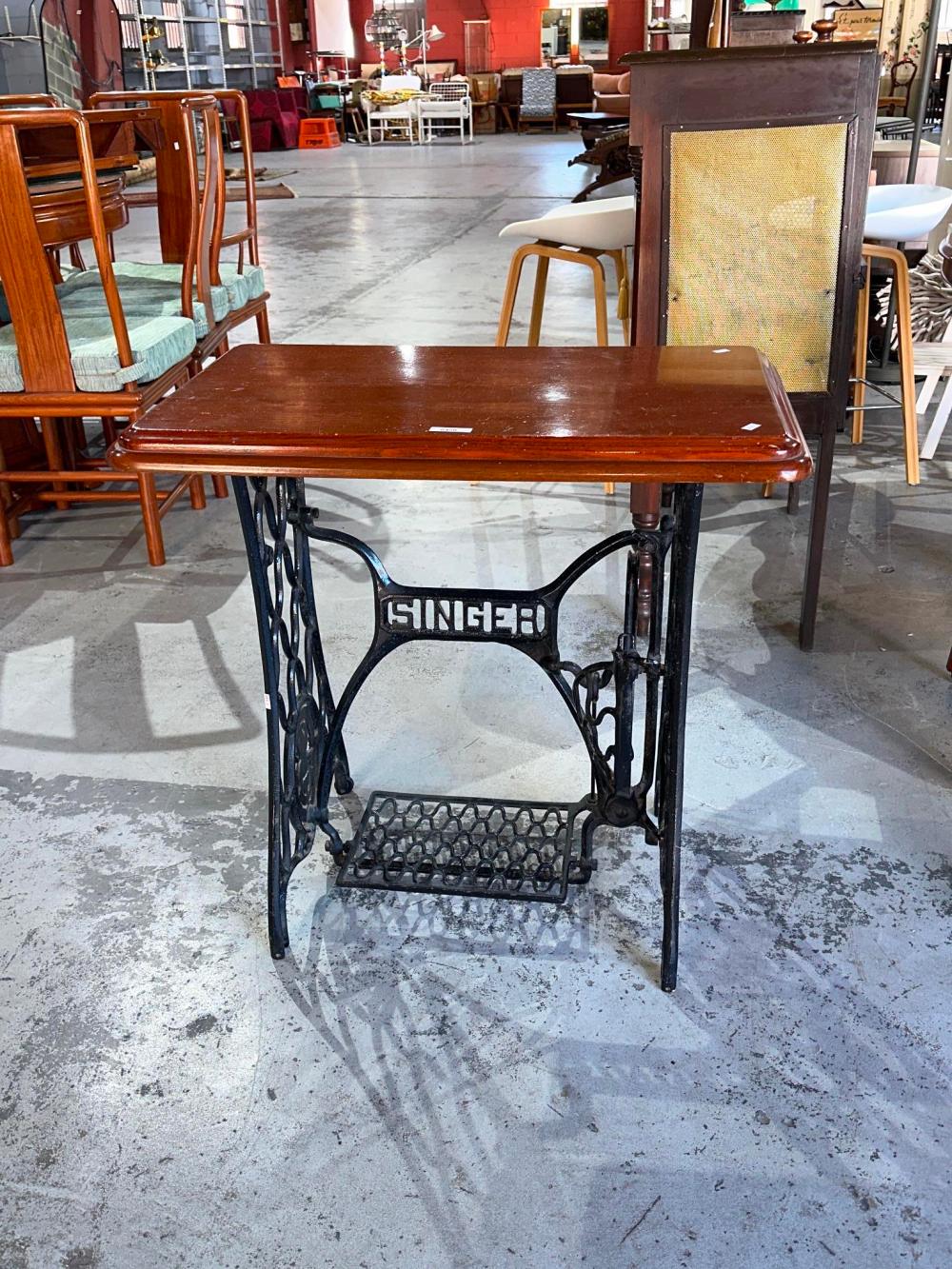 Side table with old cast-iron Singer sewing machine, treadle base, and timber top. 74 cm wide, 44.5 cm deep, 73 cm high. sold by Bargain Hunt Auctions, lot 6450 — auction record photograph