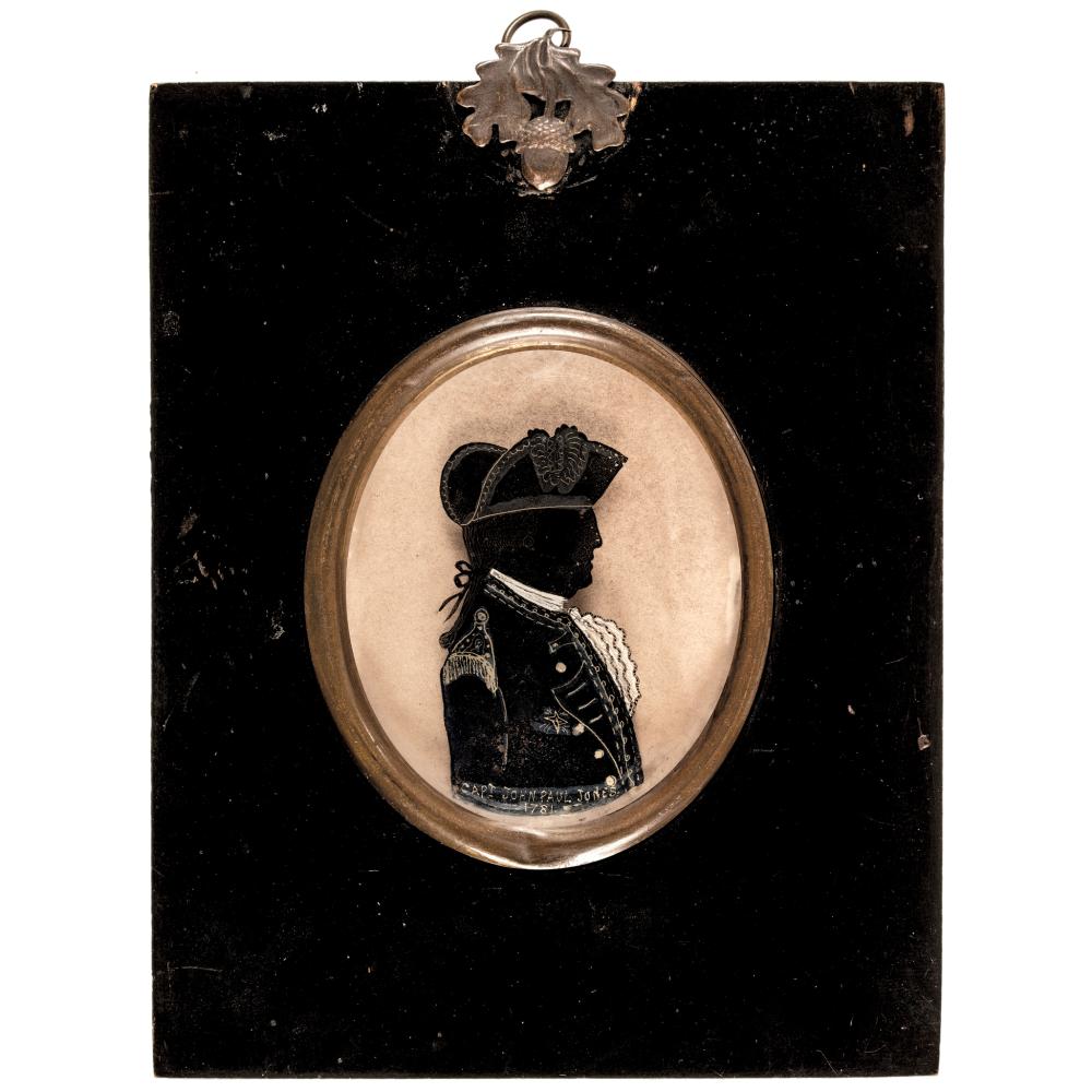 Oval silhouette portrait of a uniformed naval officer mounted in an ornate frame, set against a dark rectangular backing with a metal top clasp.