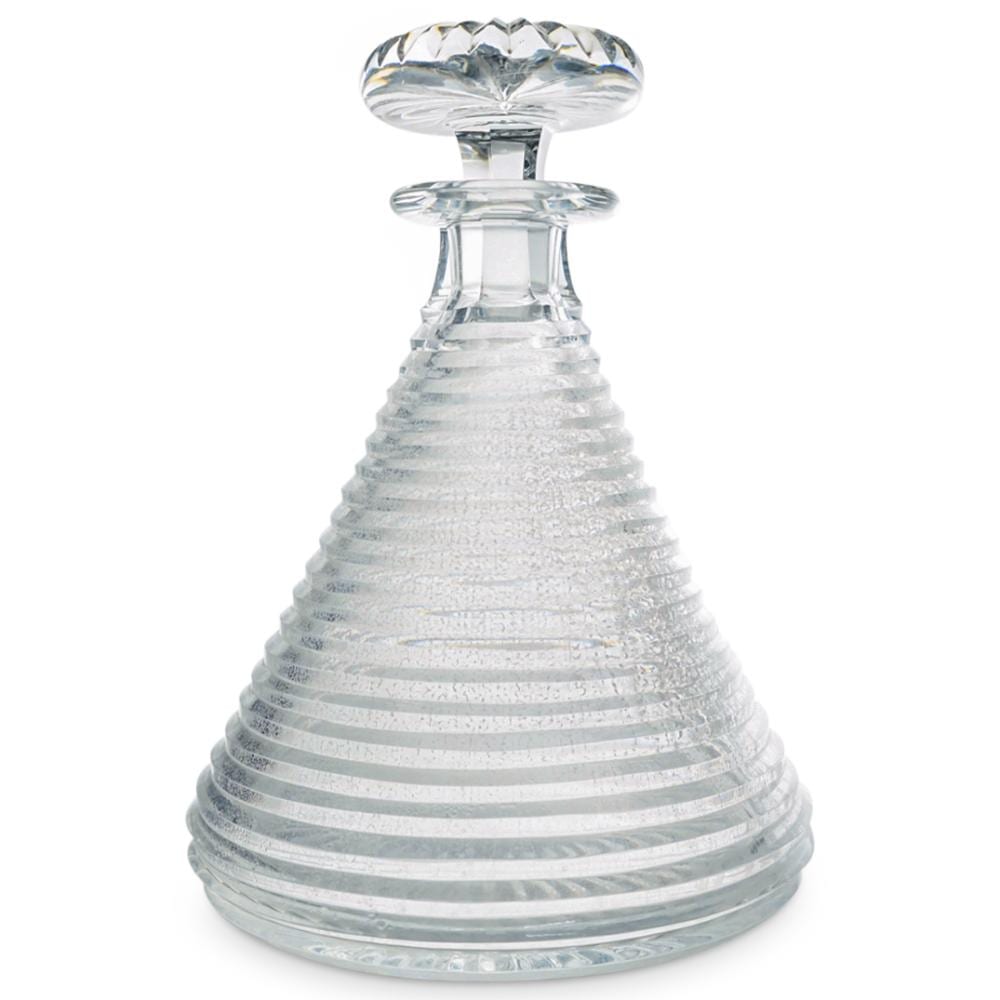 Clear cut-glass decanter with faceted stopper on a white background.