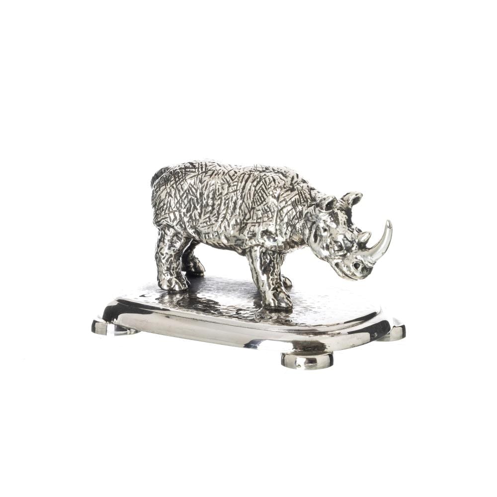 Silver-toned rhino figurine standing on a circular base, shown in a three-quarter side view against a white background.