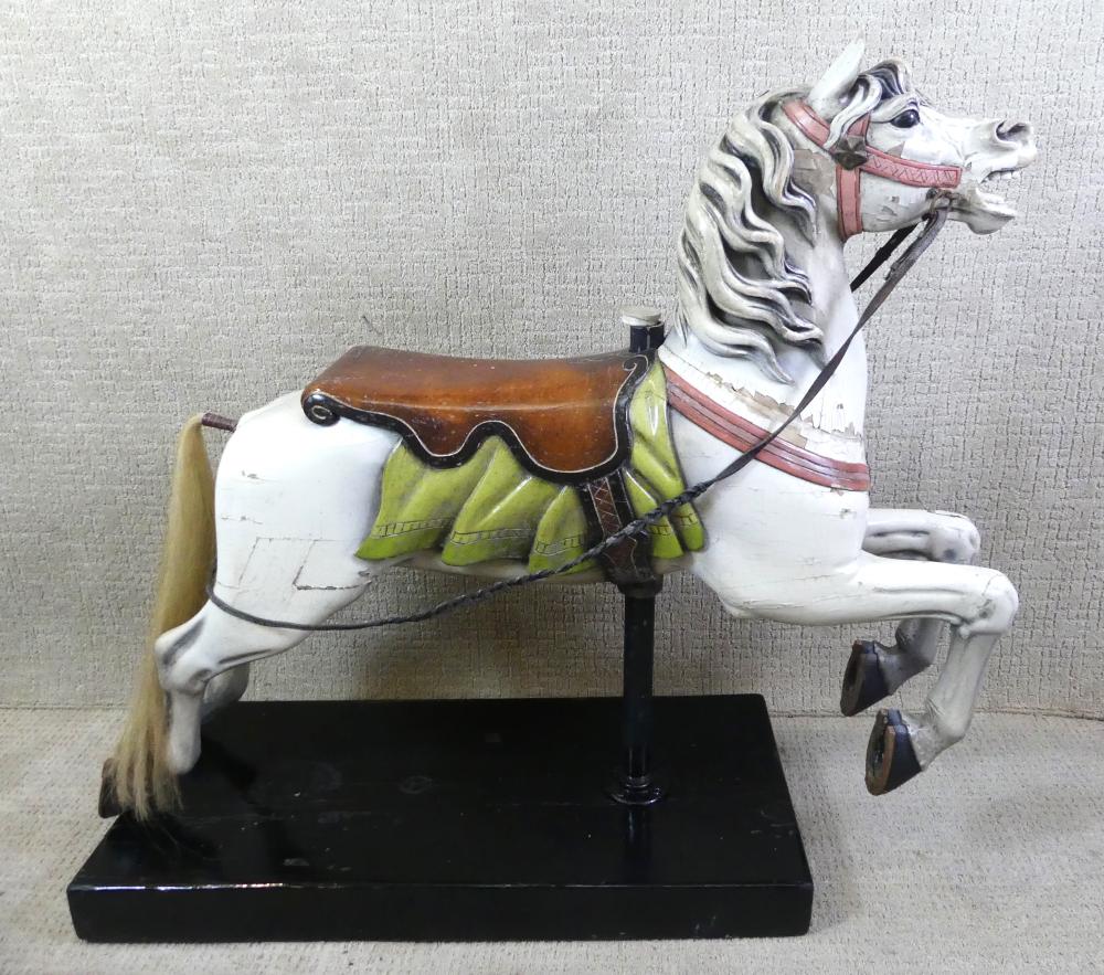 Painted carousel horse figurine on a black base, shown in side profile with a brown saddle and striped mane.