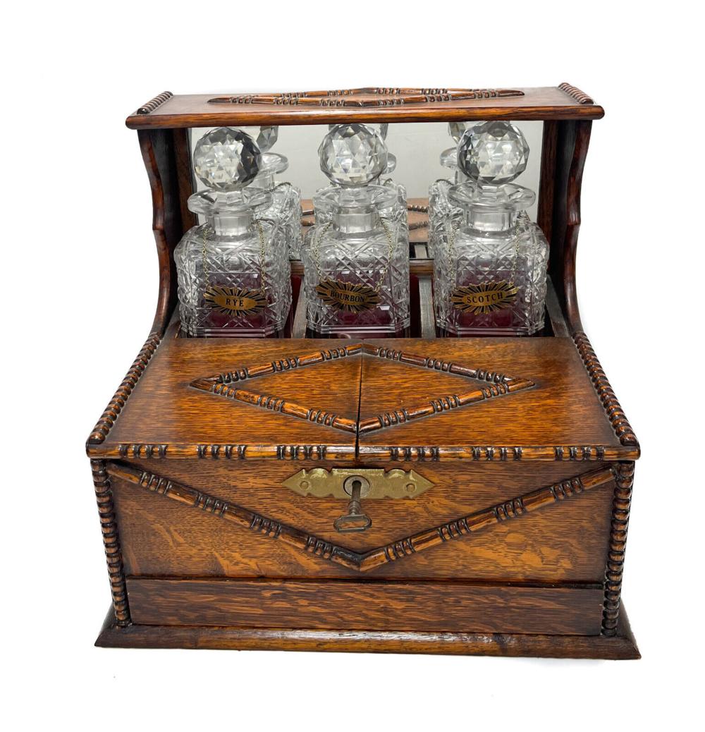 American Oak Wood Cut Glass Encased Whiskey Decanters with Cigar Humidor, c1930 sold by Taylor & Harris, lot 402 — auction record photograph