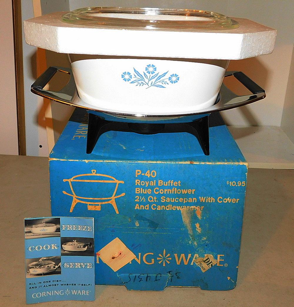 Vintage blue-and-white cornflower ceramic sauce pot with metal warmer stand, with a lid on top and a blue box in the foreground.