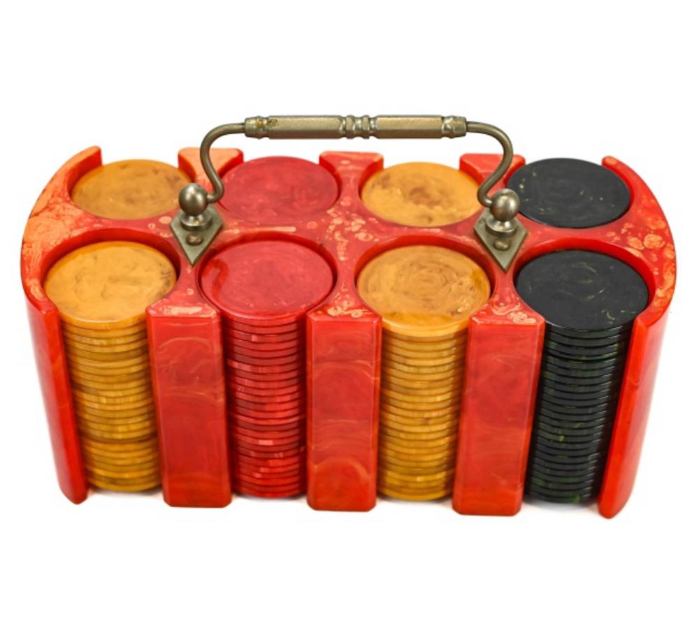 Red plastic poker chip caddy filled with stacked poker chips in red, yellow, and black colors.