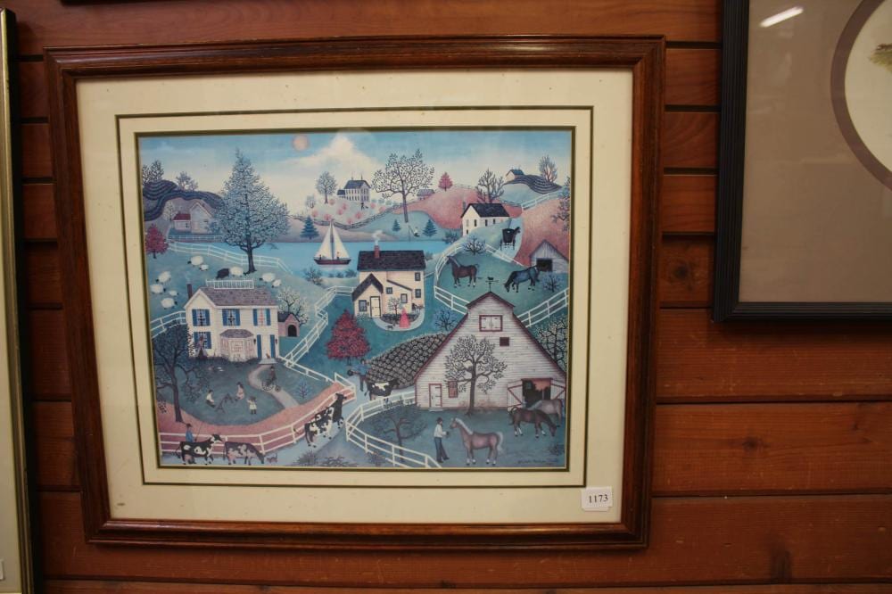 Framed winter village scene print with snow-covered houses, trees, and animals, including cows and dogs.