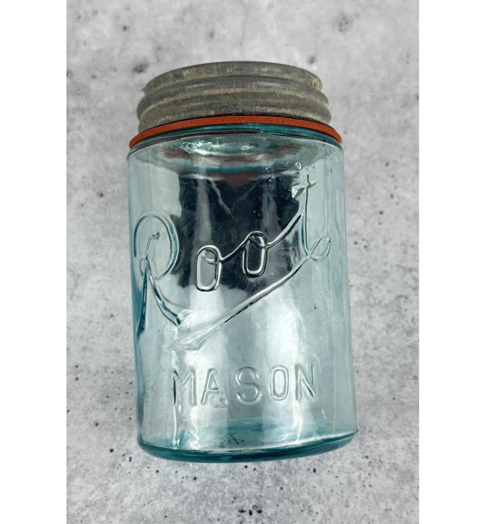 Aqua-blue glass mason jar with embossed “Root” and “MA SON” text, shown upright with a metal lid.