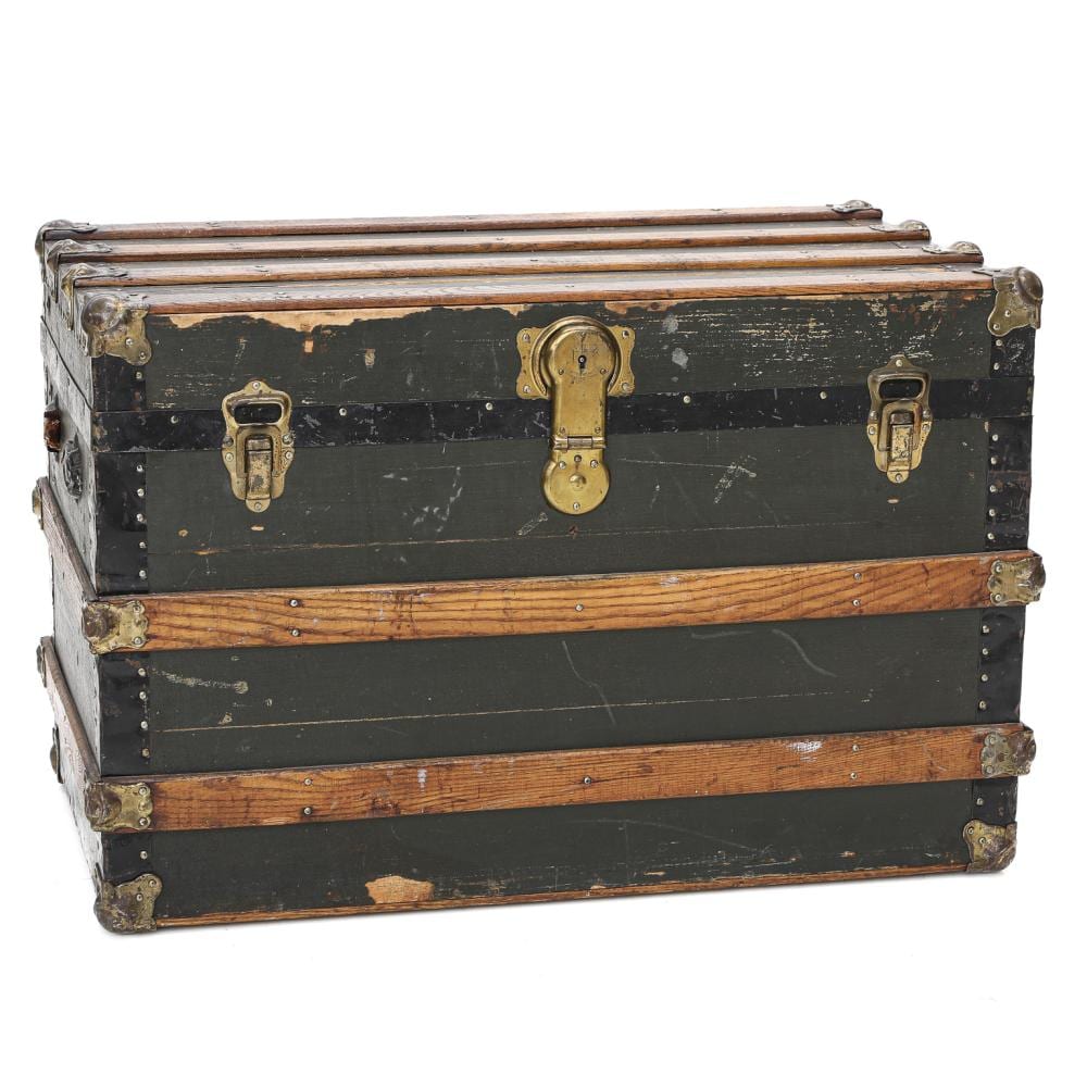 Vintage rectangular travel trunk with dark panels, brass-colored metal corner brackets, and a central lock on the front.
