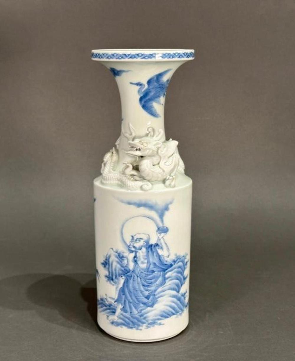 Porcelain Japanese-style vase with blue-and-white decoration of a dragon or bird, and a guardian figure at the neck
