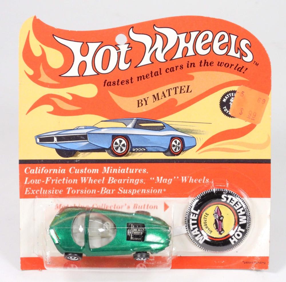 Hot Wheels blister pack showing a green and silver miniature car and a circular “Steel Hot Wheels” logo card insert.