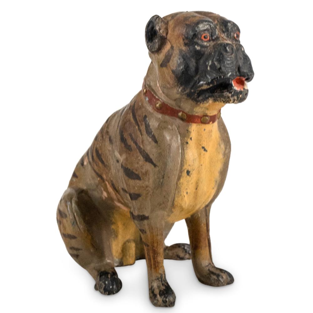 Painted dog sculpture with spotted brown and black coat and a red collar, shown in a front three-quarter view on a white background.