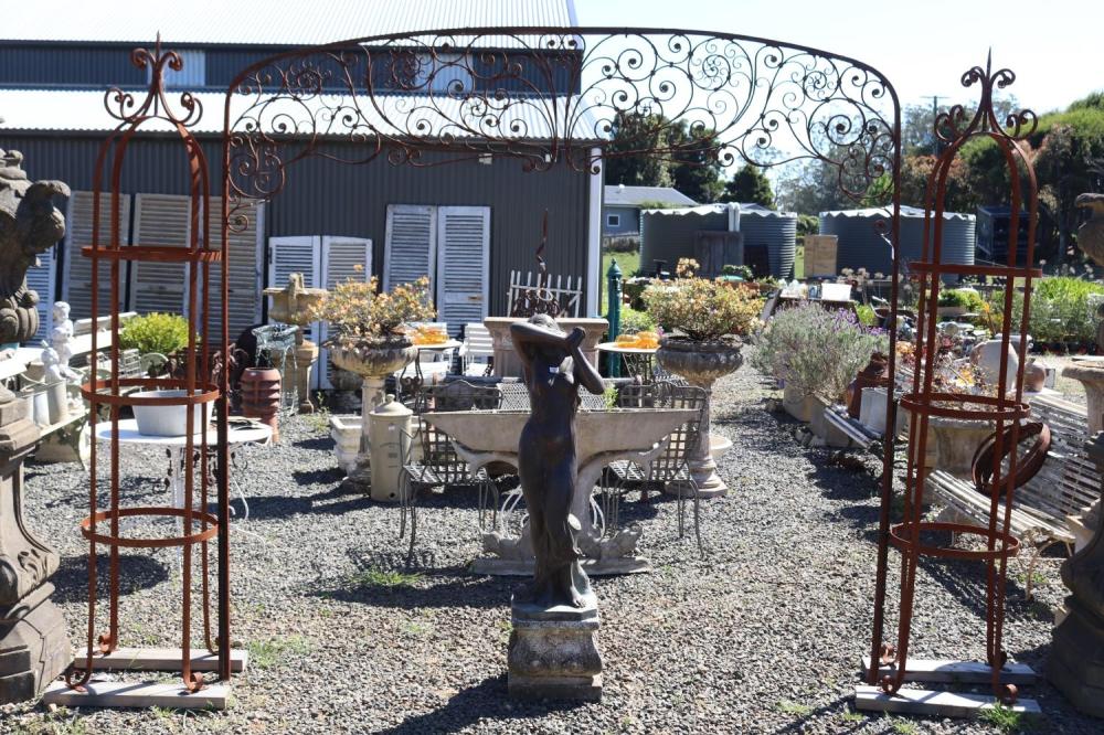 Antique French iron two piece arbor, top section with scrolling iron foliage with applied pressed metal flower heads, approx 250cm H x 250cm W sold by Vickers & Hoad, lot 18 — auction record photograph