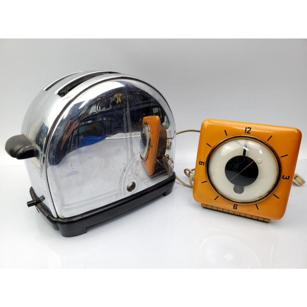 Two vintage countertop toaster appliances: a chrome hood toaster and an orange dial-style toaster, shown side by side on a white surface.
