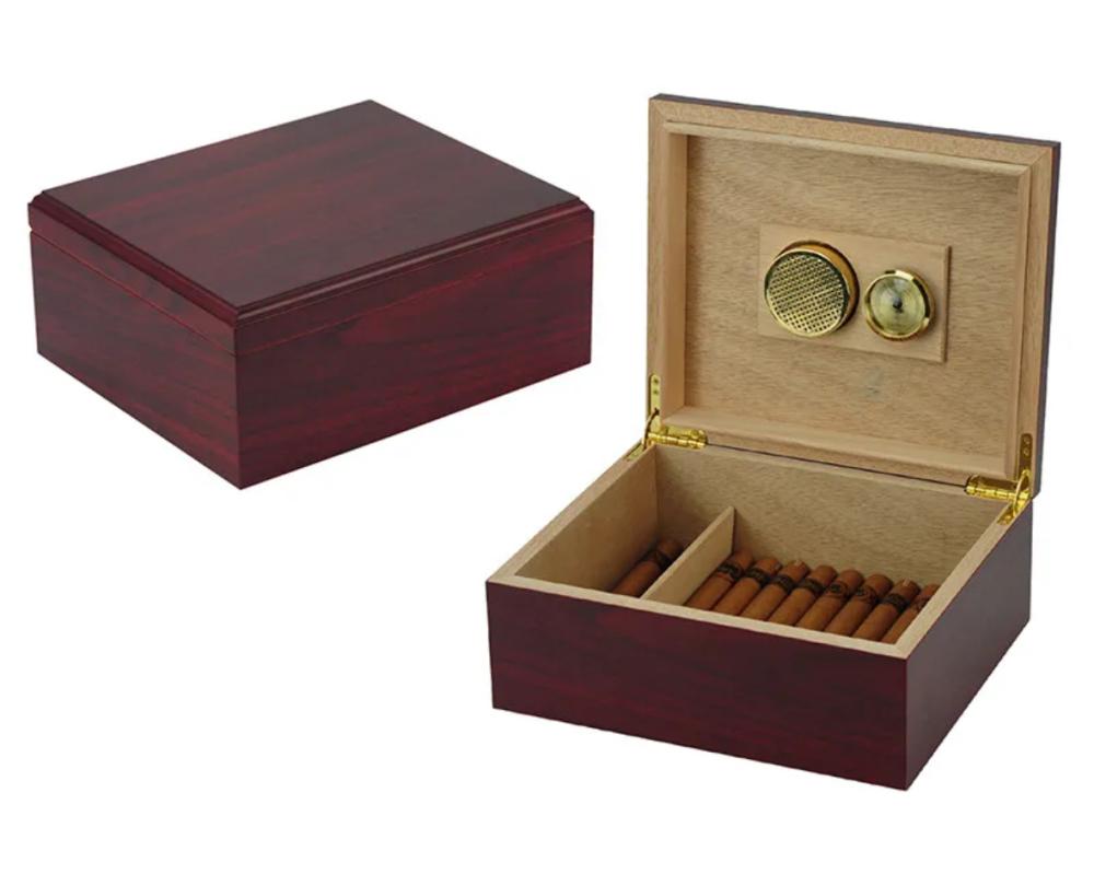Red wooden cigar humidor box with open lid showing cigar row and built-in humidifier controls on the interior panel.