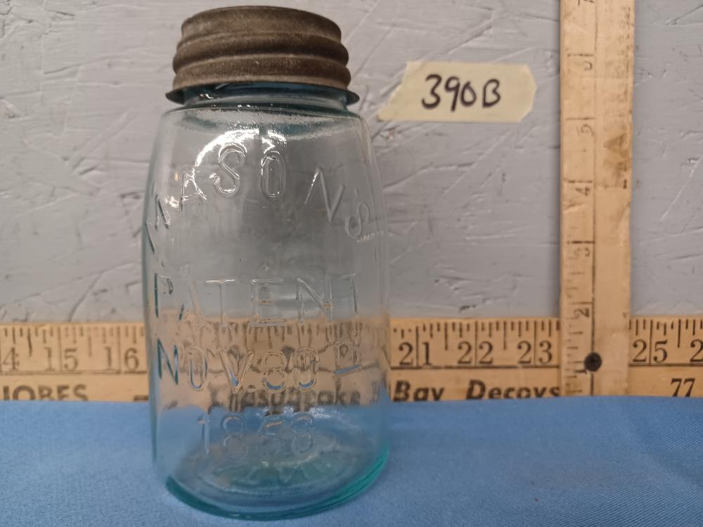 Clear glass mason jar with blue base and two-part lid, shown upright with “Mason” lettering on the jar front.