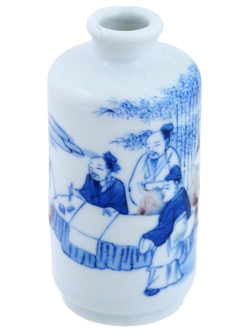 White porcelain snuff bottle with blue-and-white painted figures and bamboo-style decoration on the body.