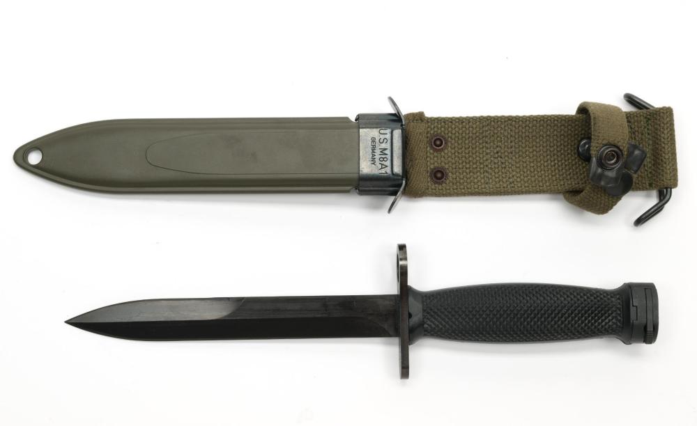 Two military-style fixed knives shown side by side: a green bayonet with a scabbard and a black-handled knife with a sheath.