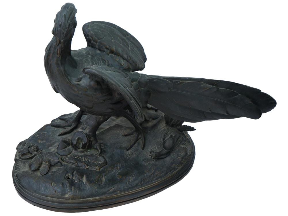 Dark metal pheasant sculpture with wings spread and a raised bird standing on an oval base.