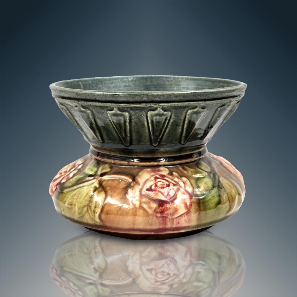 Glazed ceramic spittoon with a fluted rim and rose decoration in green, tan, and red tones.