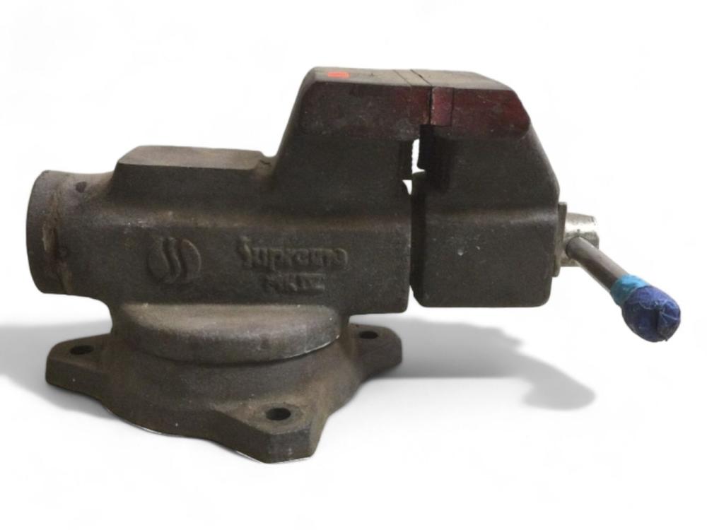 Cast metal bench vise with jaw and threaded handle, shown on a white background.