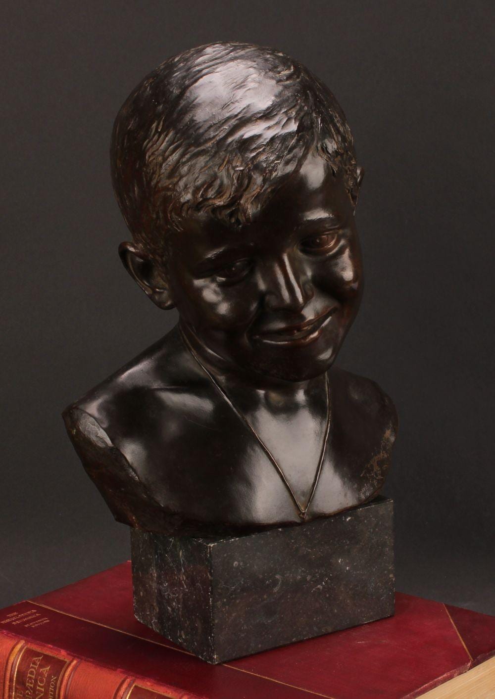 Eduardo Rossi comparable auction result: eduardo rossi 1867 1926 a brown patinated bronze bust of a young boy signed in the maquette marble base 40cm high