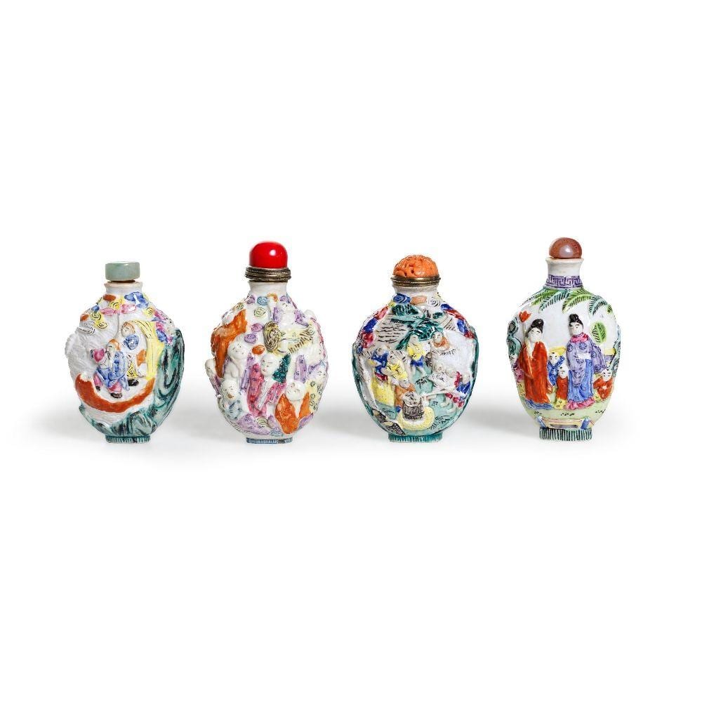 Four Chinese famille rose moulded snuff bottles sold by Roseberys, lot 209 — auction record photograph