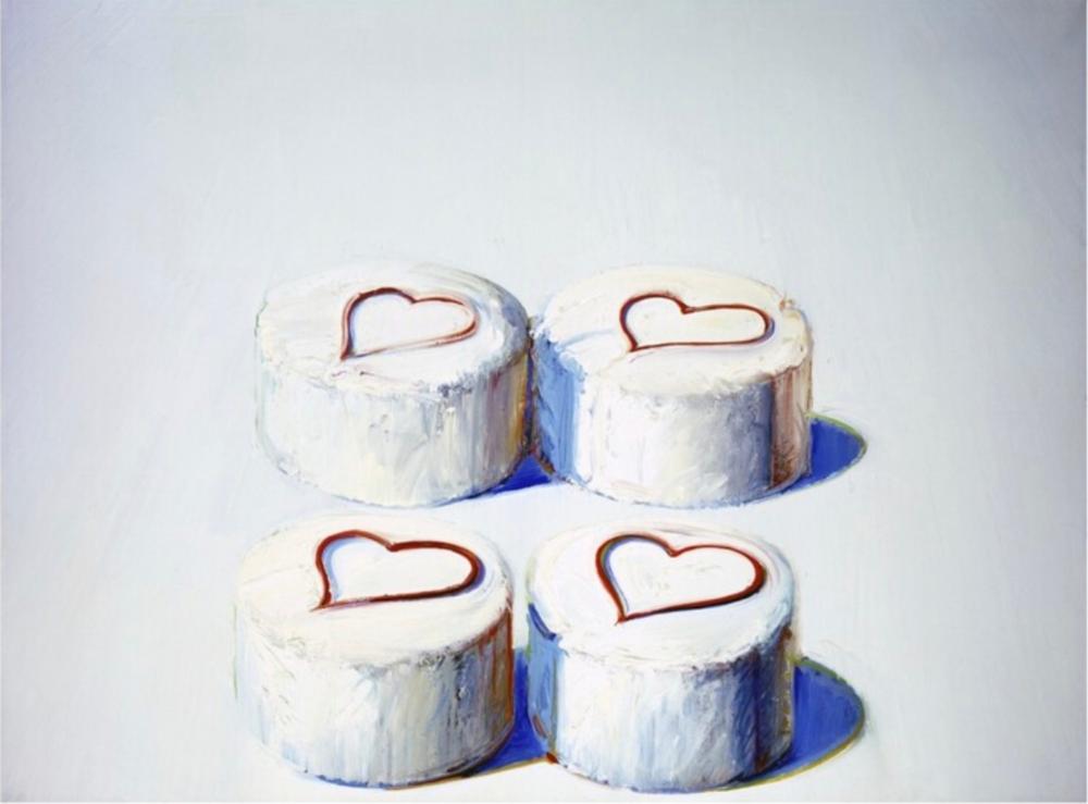 Four white frosted cakes with heart-shaped red outlines on top, arranged in a 2x2 layout against a light background.