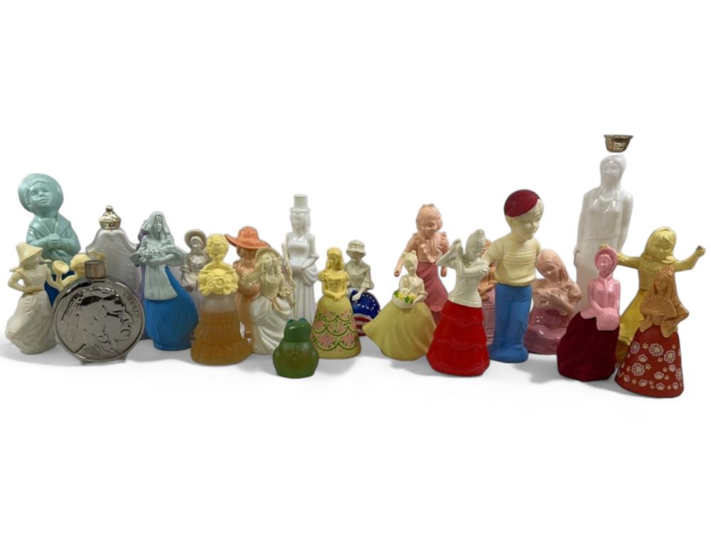 Group of small decorative perfume bottle figurines and one round coin-like bottle cap, arranged in a row on a white background.