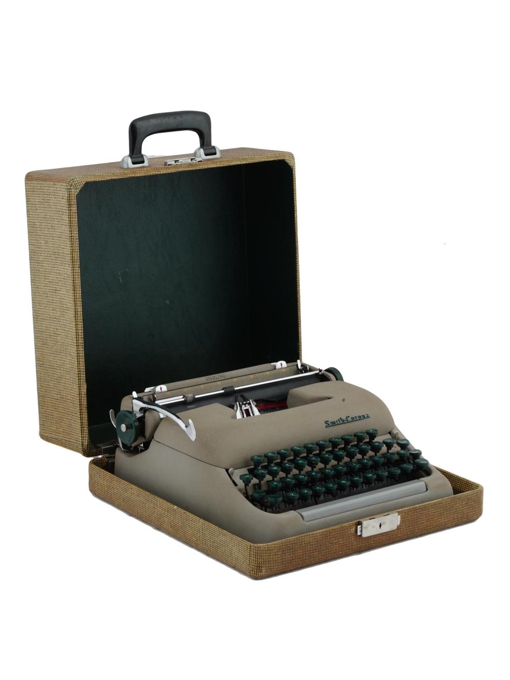 Vintage portable typewriter in a textured carrying case with keys visible and lid open.