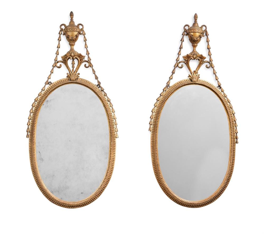 Robert Adam comparable auction result: a pair of george iii carved giltwood oval mirrors circa 1800 after designs by robert adam