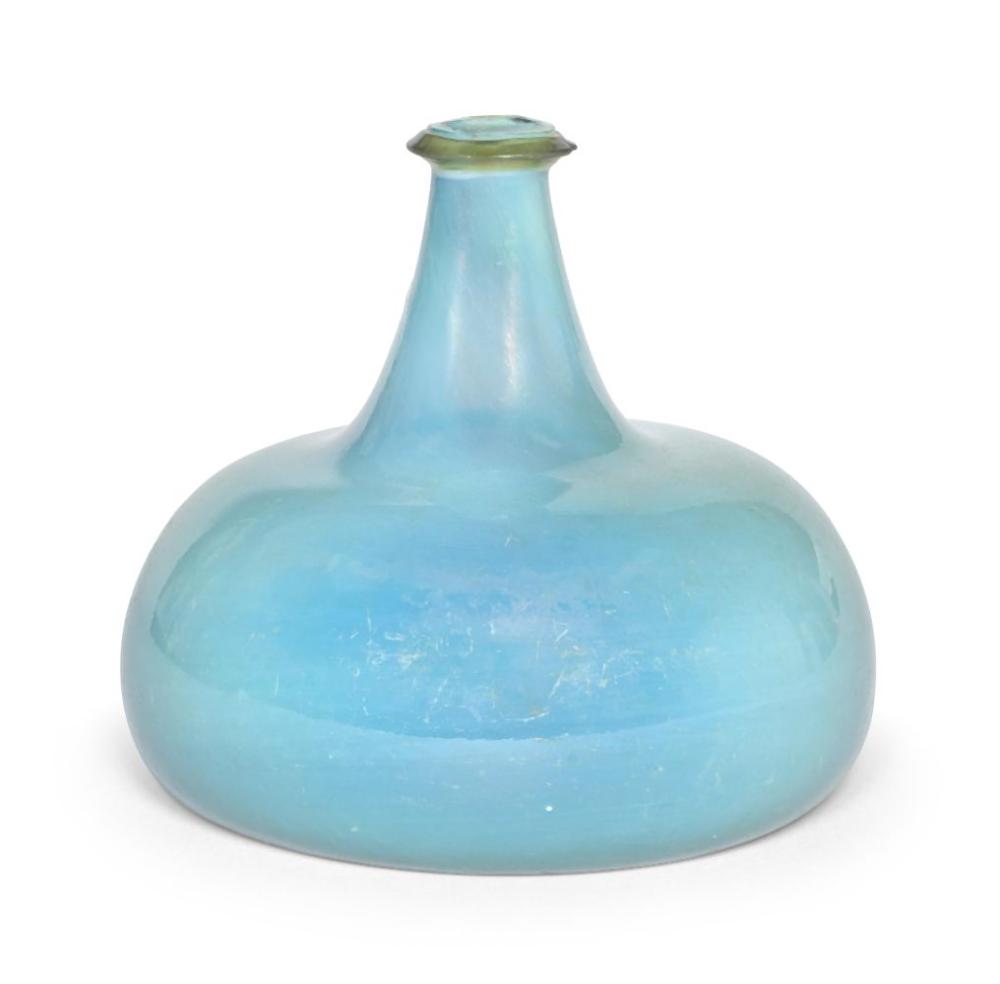 Blue opalescent glass wine bottle with a flared shoulder and narrow neck, photographed against a white background.