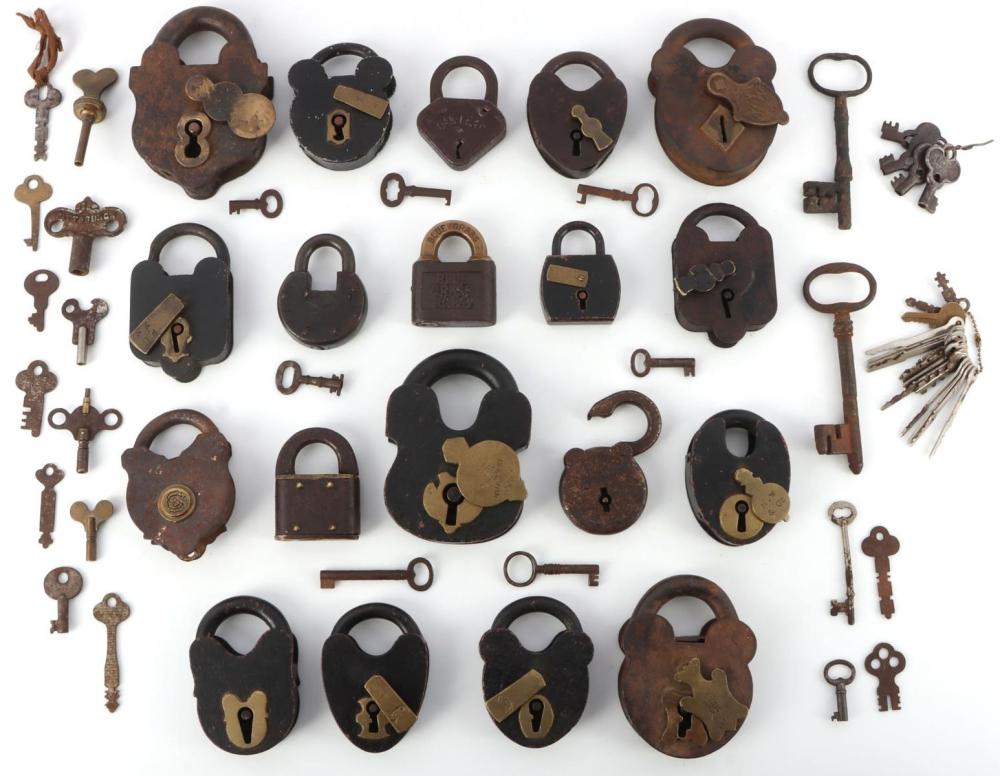 Assorted antique-style padlocks of different shapes and keys laid out on a white background.