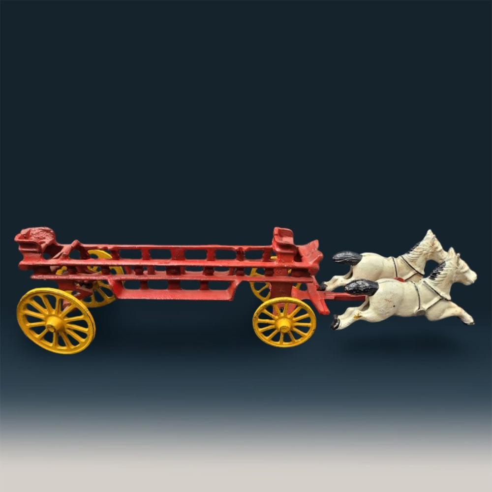 A red toy fire truck with yellow wheels is attached to a white cast-iron horse pulling it.