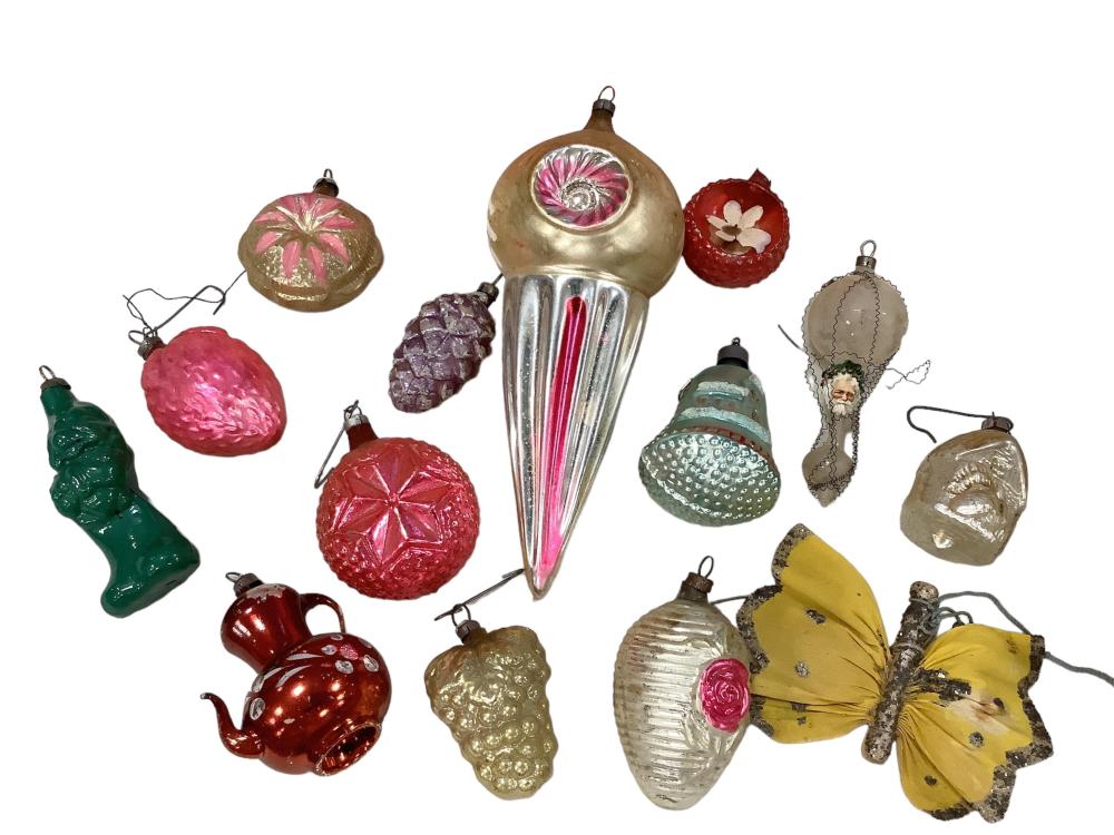 Assorted antique-style Christmas tree ornaments, including a teardrop bulb, bow, fruit and flower shapes, on a white background.