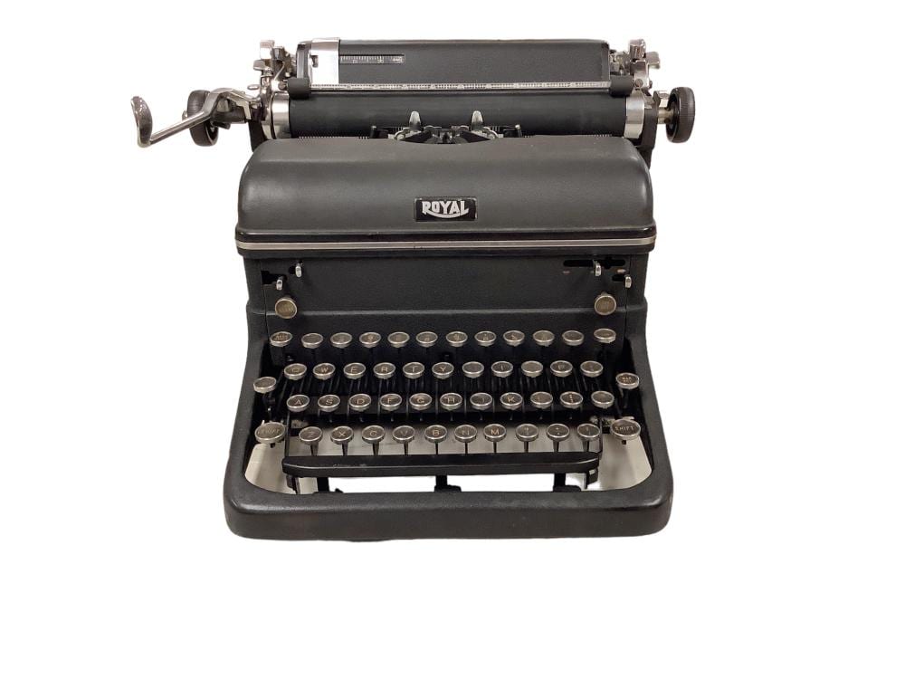 Black and silver Royal manual typewriter with visible keys and keyboard type bars on a white background.